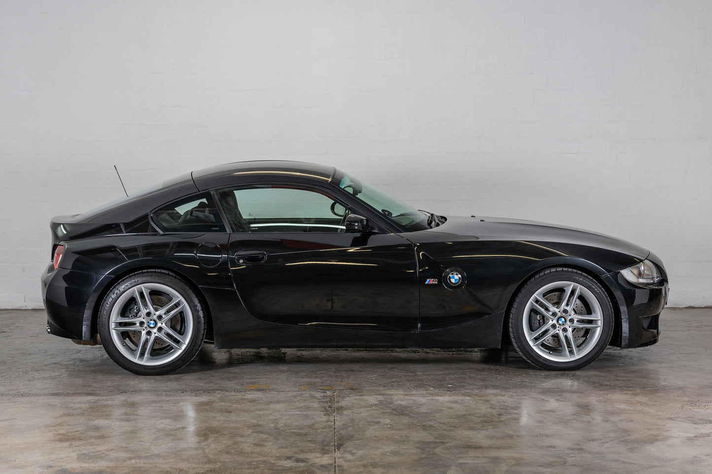 Side profile of 2007 BMW Z4 M coupe showing the wheel style and length of hood