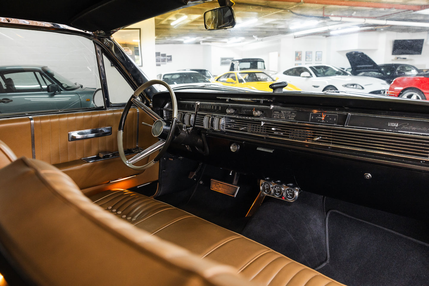 Interior of a classic car with a view of other cars in the background