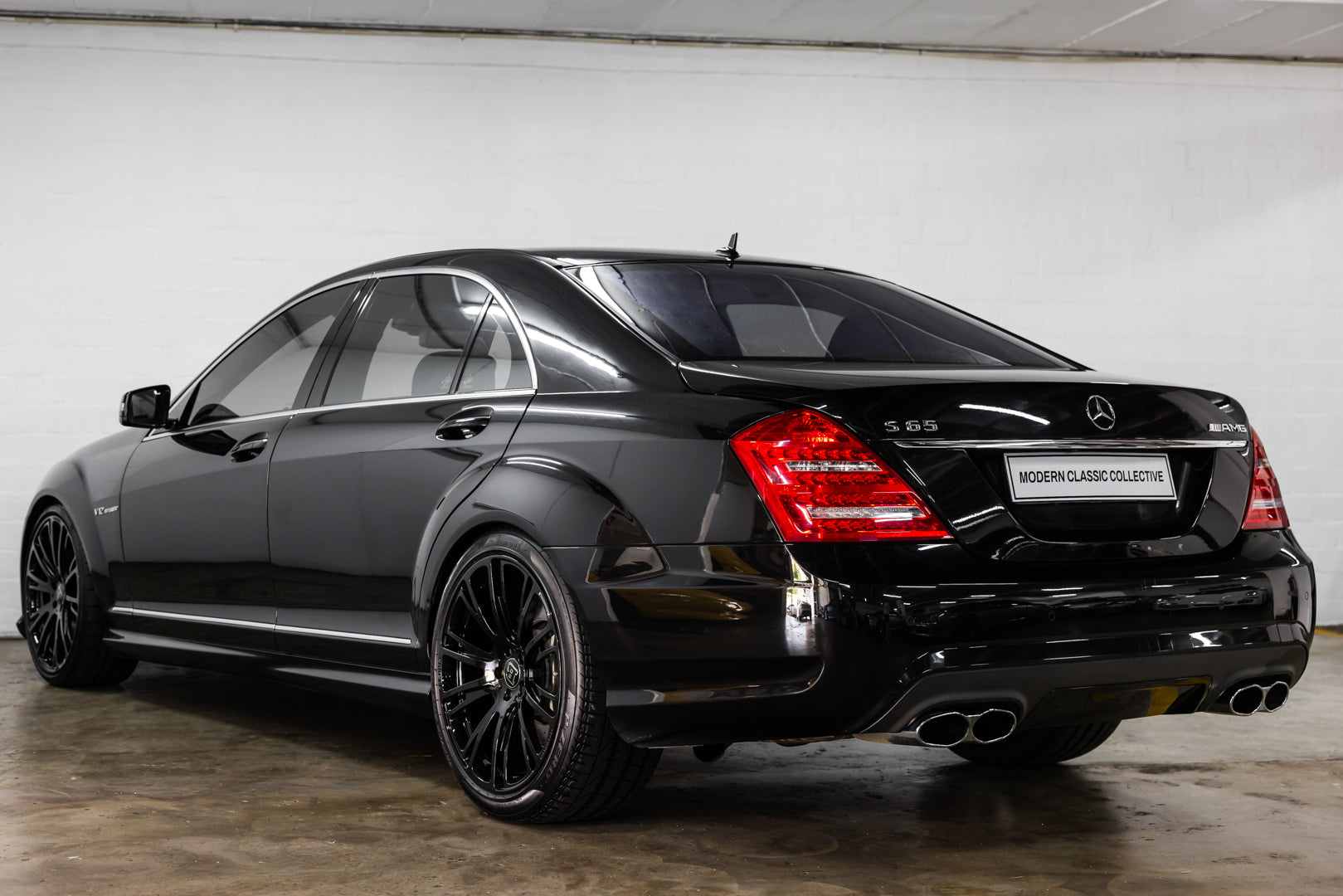 Black Mercedes-Benz S65 car in a showroom setting