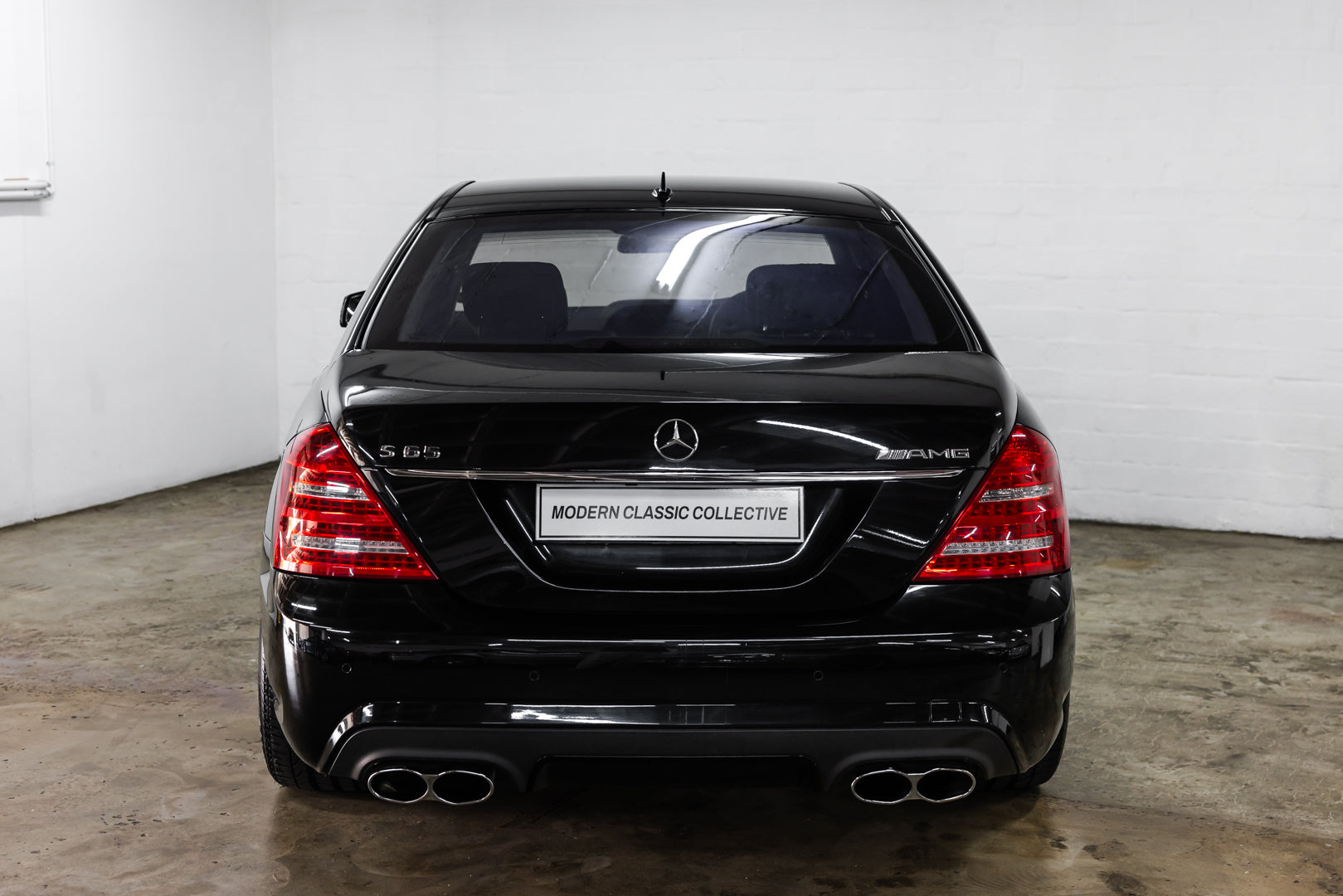 Black Mercedes-Benz car with 'Modern Classic Collective' branding on a white background